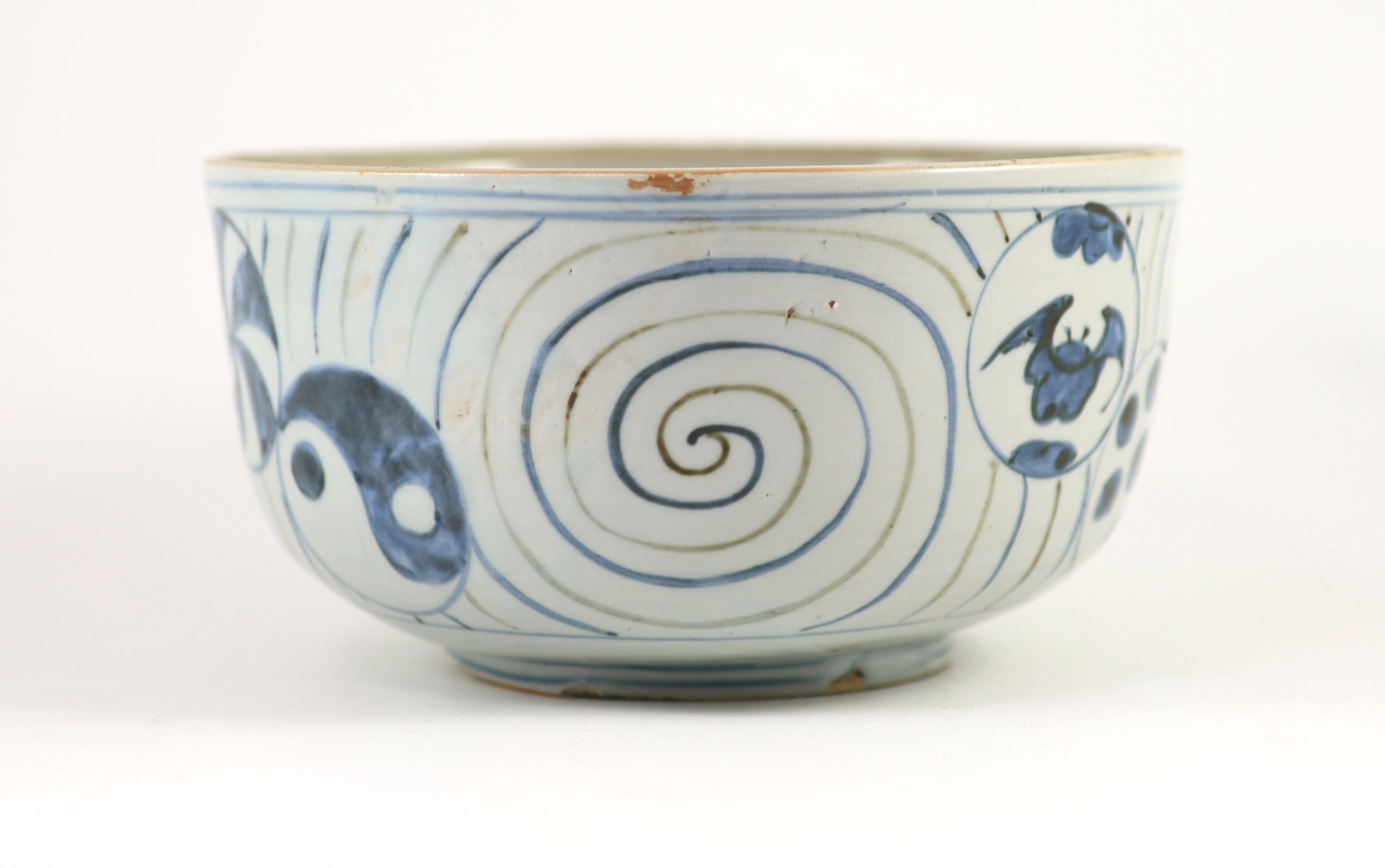 An unusual underglaze blue and iron brown bowl, probably Korean, Joseon dynasty, 18th/19th century, 23cm diameter, lacking its cover, cracked